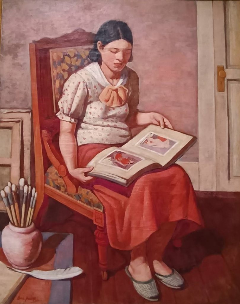 ▲李梅樹作品「看畫冊的少女」,1936年,現為國美館典藏。(記者 陳安婷/攝)