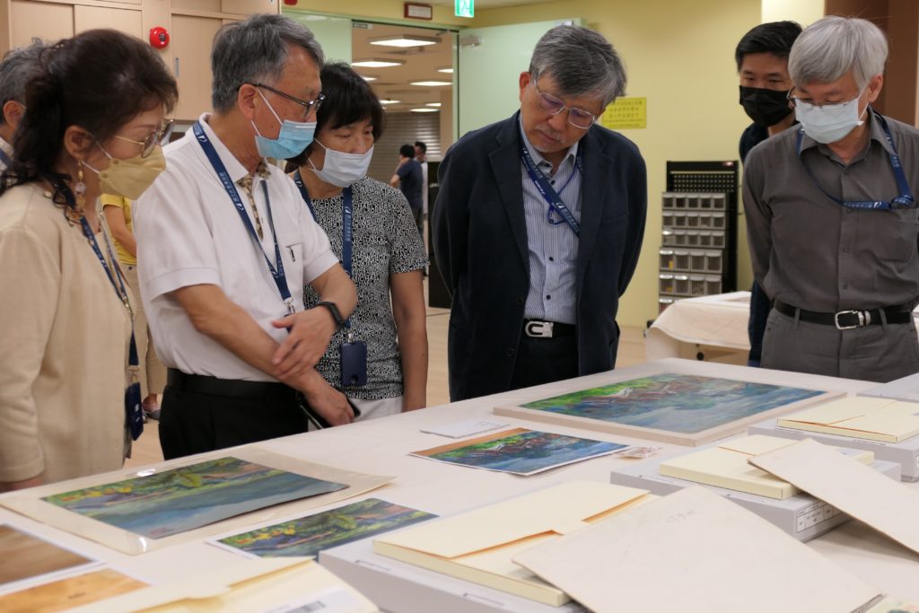 修復師為國美館廖仁義館長(右2)、林明賢組長(右1)、洪瑞麟家族代表洪柏信與張芳錱伉儷(左1及左2)，及百雪蘭女士(中)解說油畫修復過程