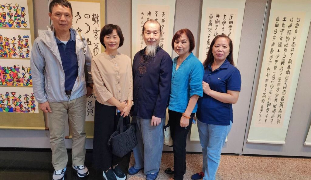 ▲陳文樹老師(中)的詩書畫師生聯展,多位書法家前來表達道賀並開心合影留念。(記者 詹佳綺/攝)