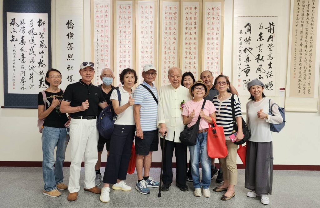▲書法家陳衛曾教授（左六）與他的學生及好友們在開幕式現場開心合影留念。（記者 辛澎祥/攝）