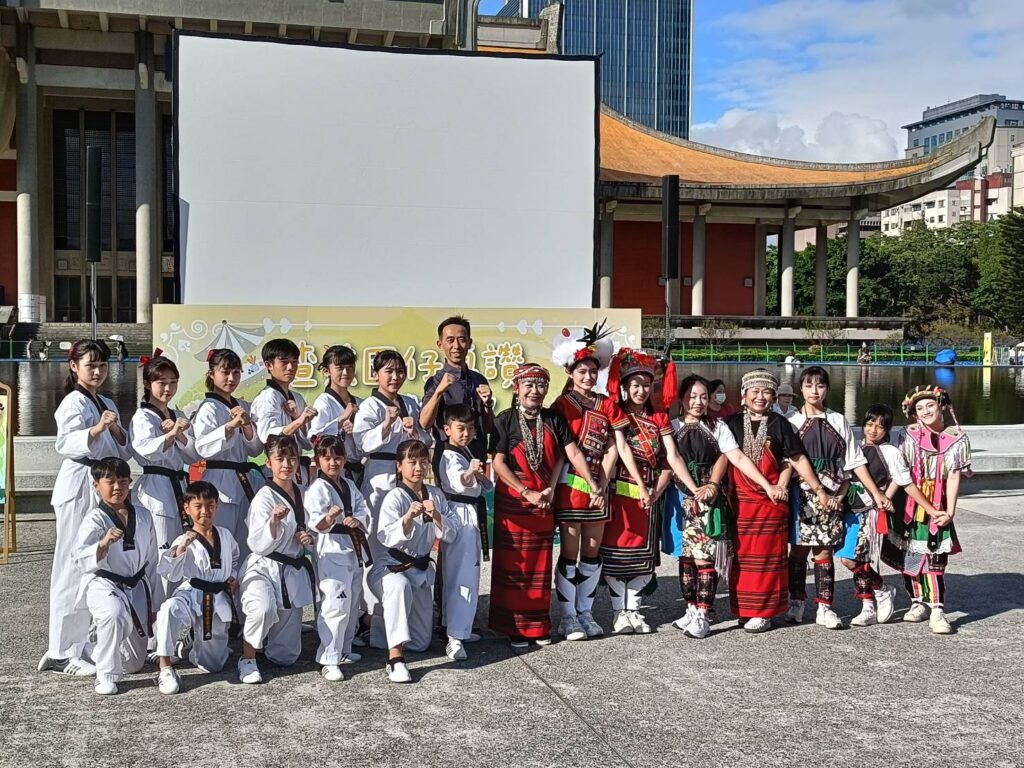 王蘭生館長（中）與廣場市集活動的原住民舞蹈者及跆拳道表演者開心合影。（記者 陳安婷/攝）
