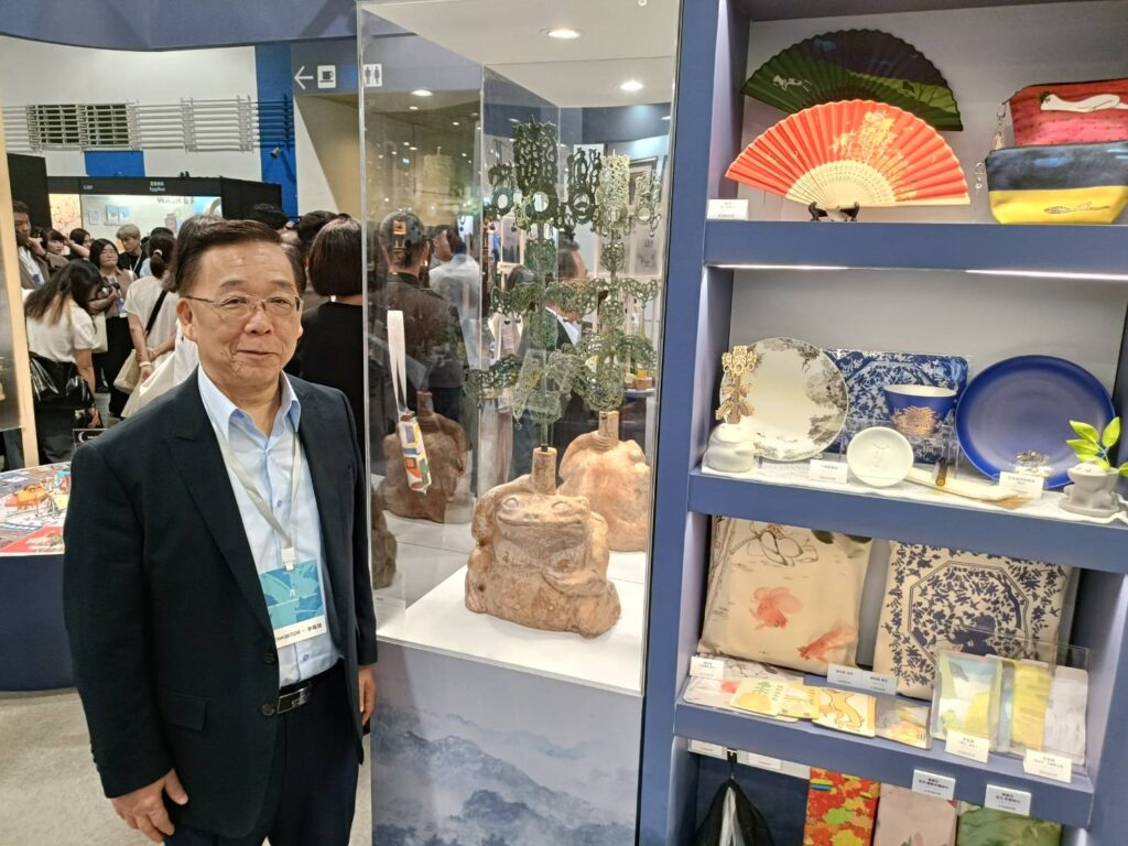 ▲史博館館長洪世佑在自家展攤前行銷「搖錢樹」文創商品,成為與會貴賓矚目焦點。(記者 辛澎祥/攝)