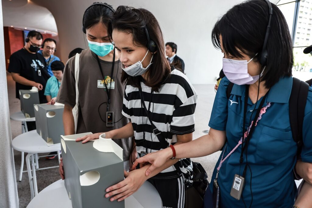 臺中市立啟明學校師生於臺中國家歌劇院進行口述影像導覽，透過輔具觸摸與感官引導，認識劇場建築特色與空間機能。（圖/國立臺灣交響樂團提供）