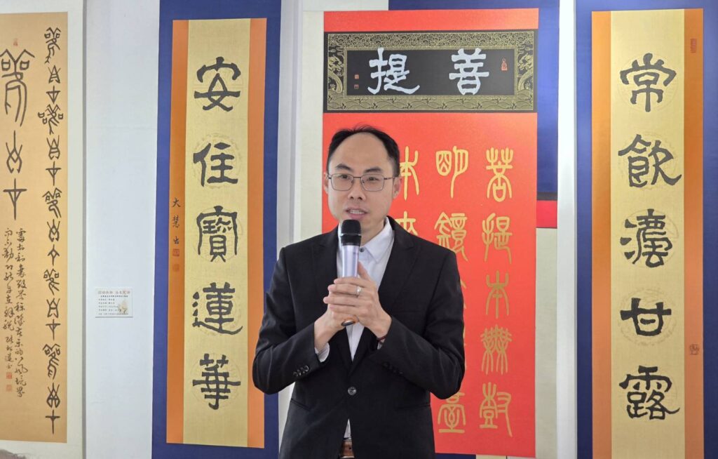 ▲華梵大學佛教藝術系主任陳俊吉教授指出,透過這次以多種媒材所創作出的佛畫與佛經作品,確實呈現出不同於以往的佛法表現手法,是藝術轉化的全新境界。(記者 詹佳綺/攝)