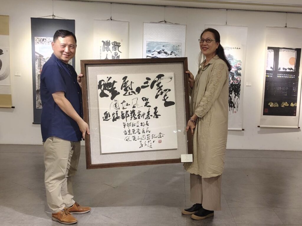 ▲雲台藝術研究中心執行長李安榮（右）贈送李奇茂大師八八風災而創作的書法作品給台東縣政府，由臺東縣副縣長王志輝代表接受，捐贈場面溫馨感人。（圖/林永發 提供）